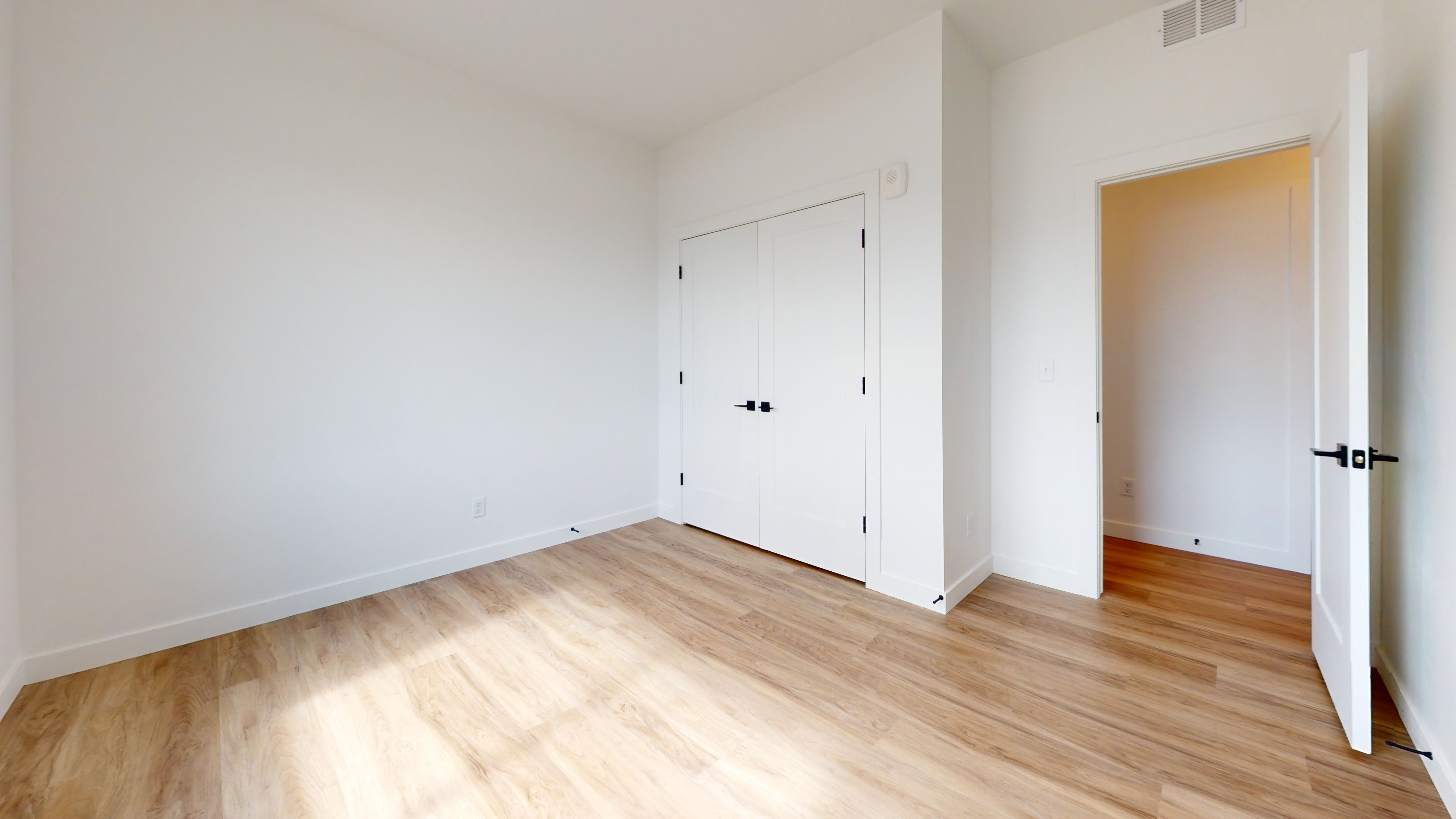 Unfurnished bedroom featuring light wood-type flooring and a closet