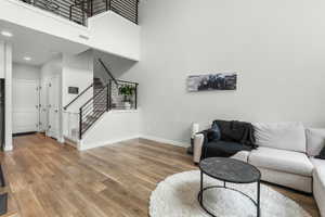 Living room featuring wood-type flooring and a high ceiling