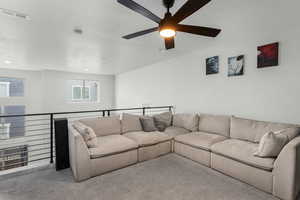 Carpeted living room with a textured ceiling