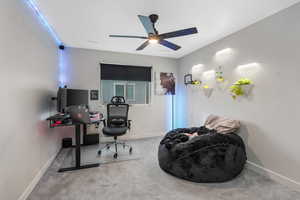 Carpeted office space with ceiling fan