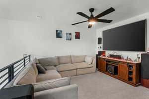 Living room featuring light carpet and ceiling fan