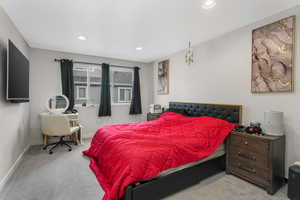 Bedroom with light colored carpet