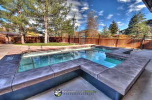 View of pool featuring an in ground hot tub and a patio area