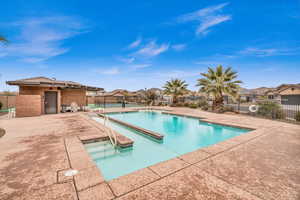 View of swimming pool featuring a patio area and a hot tub