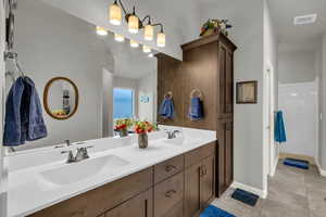 Bathroom featuring tile patterned floors and vanity