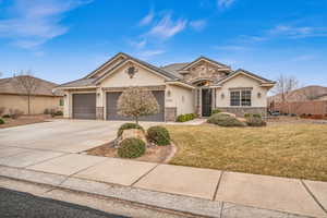 Ranch-style home with a front lawn and a garage