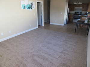 Unfurnished living room featuring carpet flooring