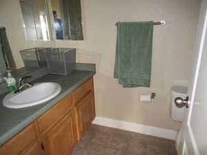 Bathroom with tile patterned floors, toilet, and vanity