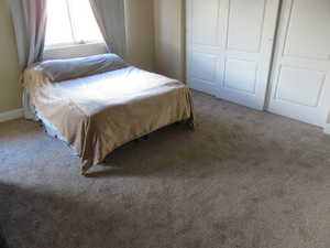 Bedroom featuring a closet and carpet floors