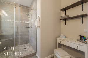 primary bathroom featuring an custom tile shower