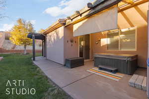 Exterior space with a pergola and a hot tub