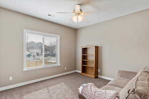 Unfurnished room featuring carpet and ceiling fan