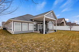 Back of property featuring a patio, a lawn, and central AC