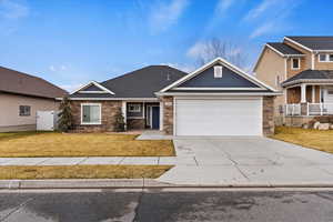 Craftsman-style house with a front lawn and a garage