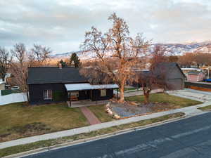 View of front of property featuring a garage, a mountain view, and a front yard