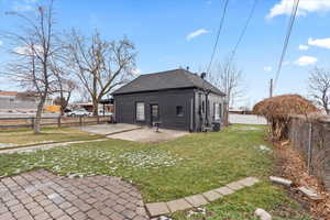 Back of house featuring a yard, a patio, and partially fenced yard