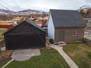 Exterior space with a mountain view and a lawn