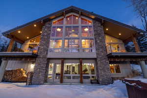 Snow covered property featuring a balcony