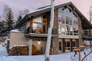 Snow covered property featuring a balcony