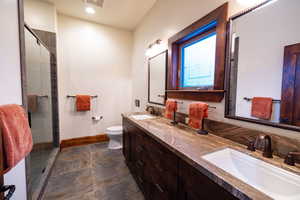 Bathroom with vanity, toilet, and walk in shower