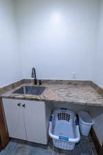 Interior space with sink and white cabinetry