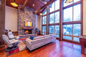 Living room featuring a fireplace, wood ceiling, and hardwood / wood-style floors