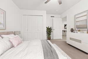 Bedroom with carpet flooring, a closet, and a ceiling fan