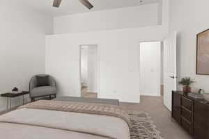 Bedroom featuring baseboards, light carpet, a ceiling fan, and connected bathroom