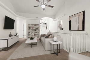 Living area featuring a ceiling fan, light carpet, lofted ceiling, a chandelier, and arched walkways