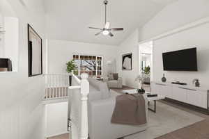 Living area with ceiling fan and high vaulted ceiling