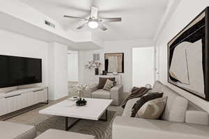 Living room with ceiling fan, light tile patterned flooring, and baseboards