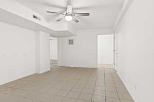 Unfurnished room with ceiling fan and baseboards