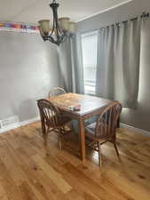 Dining room featuring light hardwood / wood-style floors and an inviting chandelier