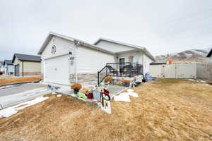 View of front of house featuring a garage and a front yard