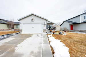 View of front of house with a front lawn and a garage