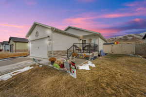 View of front of house featuring a garage and a front yard