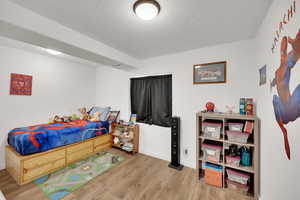 Bedroom with light hardwood / wood-style floors