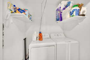 Laundry room with washer and clothes dryer