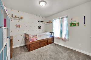 Bedroom with carpet and a textured ceiling