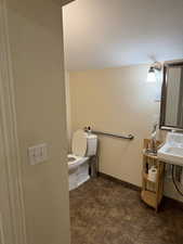 Bathroom with sink, a textured ceiling, and toilet