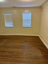 Unfurnished room with dark hardwood / wood-style floors and a textured ceiling