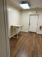 Interior space featuring ornamental molding and dark hardwood / wood-style flooring