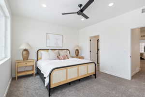 Carpeted bedroom featuring ceiling fan