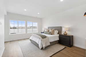 Bedroom with light hardwood / wood-style flooring