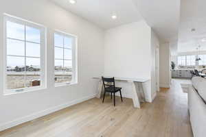 Office with light hardwood / wood-style floors