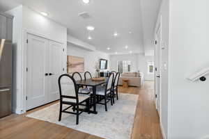 Dining room with light wood-type flooring and a textured ceiling