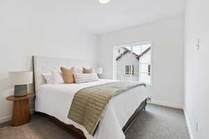 Bedroom featuring dark carpet