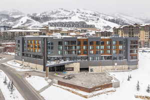 Snowy aerial view featuring a mountain view