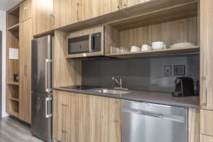 Kitchen with appliances with stainless steel finishes and sink