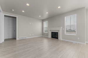 Unfurnished living room with light wood-type flooring